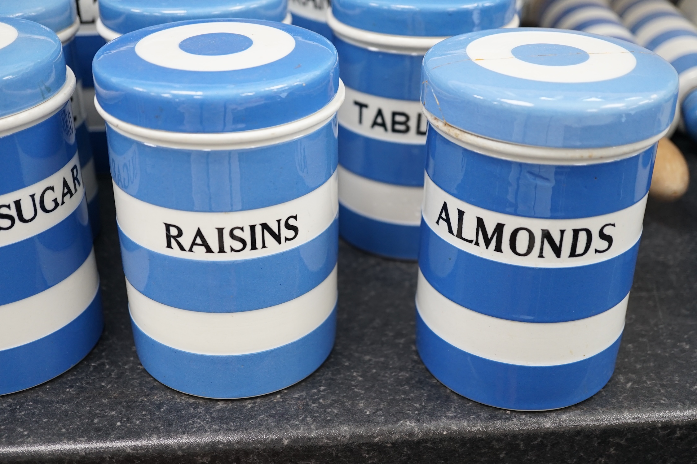 T.G.Green Cornish Kitchenware, fifteen lidded storage jars to include Meal, Granulated Sugar, Dessicated-Coconut and Sea Salt, largest 20cm high, mainly Black Shield marks. Condition - poor, fair and good